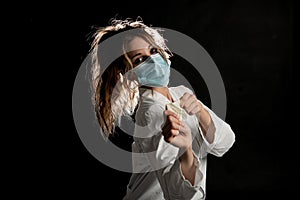 Woman wearing medical uniform taking fun with protective gloves
