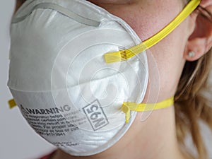 Woman Wearing an N95 Protective Dust Mask Up Close