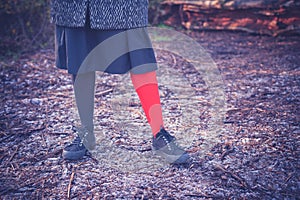 Woman wearing odd leggings on frosty ground