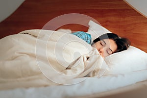 Woman Wearing Pajamas Sleeping in Her Bedroom