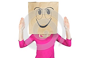 Woman wearing paper bag with happy facial expression on head