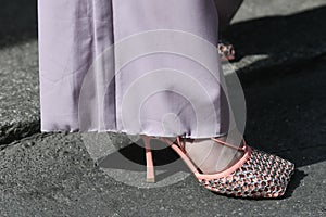 Woman wearing pink pants and elegant shoes with crystals