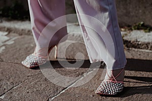 Woman wearing pink pants and elegant shoes with crystals