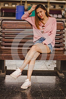 Woman sitting in a chair in a train station