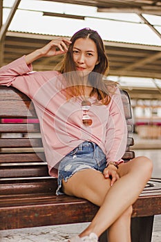 Woman sitting in a chair in a train station