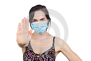 Woman wearing protective face mask making  a stop sign