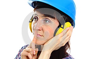 Woman wearing protective helmet and headphones, silence sign