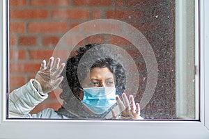 A woman wearing protective mask and gloves during quarantine during corona virus Covid-19 outbreak
