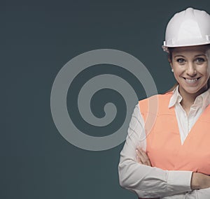 Woman wearing protective workwear and safety helmet