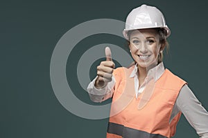 Woman wearing protective workwear and safety helmet photo