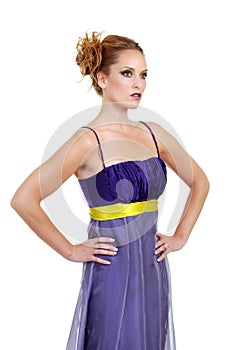 Woman wearing a purple dress with hands on her hip