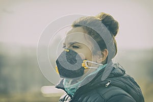 Woman wearing a real anti-pollution, anti-smog and viruses face mask