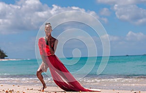 Woman Wearing Red Bikini and Dress on a tropical beach. Remote tropical beach in Barbados, Caribbean Sea. Black. Portrait