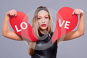 Woman wearing red dress holding big heart sign love symbol