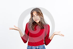 A woman wearing a red shirt shrugged, ignorant and unconcerned, what I do not know on a white background photo