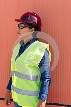 Woman wearing safety goggles and hard hat in the industry