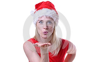 Woman wearing Santa hat and blowing a kiss