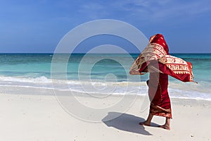 Woman wearing a sari on paradise beach.