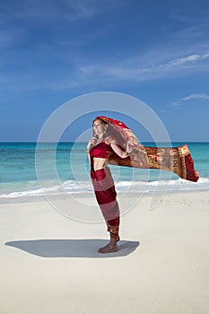 Woman wearing a sari on paradise beach.