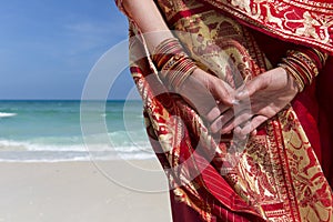 Woman wearing a sari on paradise beach.