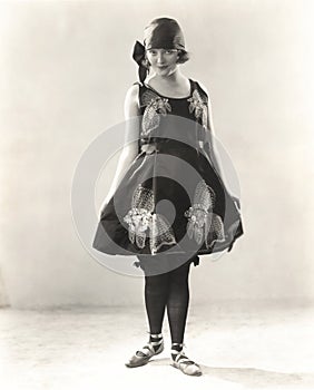 Woman wearing satin embroidered beach costume, 1920s