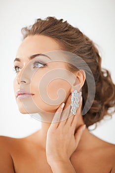 Woman wearing shiny diamond earrings