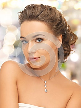 Woman wearing shiny diamond pendant