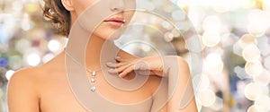 Woman wearing shiny diamond pendant