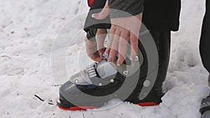 Woman wearing ski boots on your feet, and buttons special fasteners.