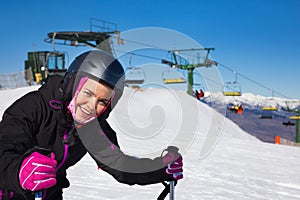 Woman wearing ski equipment and skiing in snowing mountains