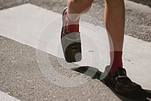 Woman wearing snake leather shoes and red socks