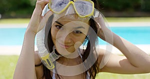 Woman wearing snorkel and swim goggles