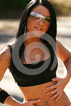 Woman wearing sports bra and sunglasses