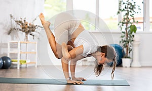 Woman wearing sportwear doing Yoga exercise, Yoga One Legged King Pigeon pose or Eka Pada Rajakapotasana, calm of