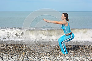 Woman wearing sporty clothers is making exercise photo