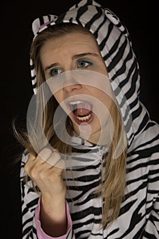 Woman wearing striped cat pajamas showing a fist closed roar