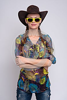 Woman wearing sunglasses and cowboy hat