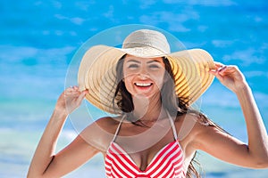 Woman wearing sunhat on beach photo