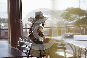 Woman Wearing Sunhat At Cafe