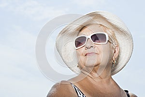 Woman wearing a sunhat and sunglasses