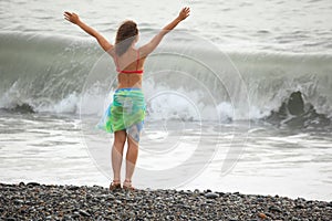 Woman wearing swimsuit is staying near water photo