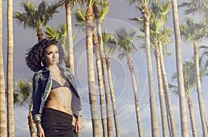 Woman wearing swimwear epic palm tree background. photo