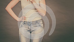 Woman wearing tight slim jeans and white tshirt