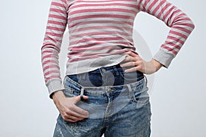 Woman wearing two jeans pants. Strange and odd fashion. She is very sloppy