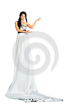 Woman wearing very long silver dress stands