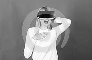 Woman wearing virtual reality goggles. Happy woman exploring augmented world, interacting with digital interface. Woman