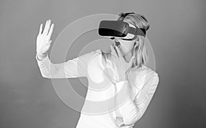 Woman wearing virtual reality goggles. Person with virtual reality helmet isolated on blue background.Woman with virtual