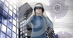 Woman wearing virtual reality headset and Tall buildings with sci-fi interface background