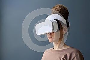 Woman Wearing VR Headset with Dread Bun on Blue