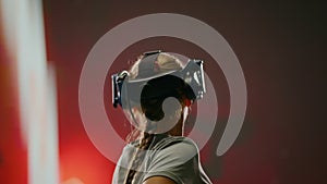 The woman wearing VR headset plays video game. Concept fun active leisure in virtual reality, high technology.The woman